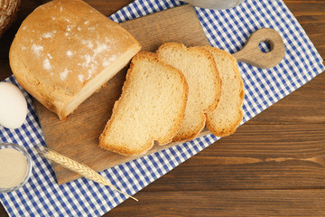 Bread and ingredients on wooden table