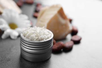 Jar with cocoa butter product on table