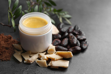 Beautiful composition with cocoa butter lotion on table