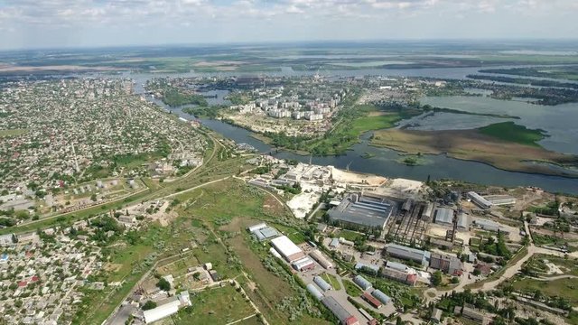 Astonishing aerial shot of Kherson city with its multistoreyed buildings, private houses, green parks, riveting riverbank, which look splendid from a bird`s eye heigh in a sunny day in summer.