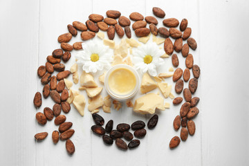 Beautiful composition with cocoa butter lotion on table