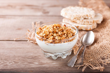 Muesli and yogurt in a glass on a table. Selective focus. Copy space for text