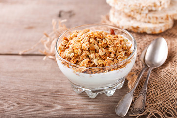 Muesli and yogurt in a glass on a table. Selective focus. Copy space for text