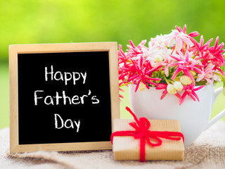 Fototapeta na wymiar Father's Day concept. Poster mock up template with Happy Father's Day text and flower bouquet, marshmallow in the shape of heart and gift over green background