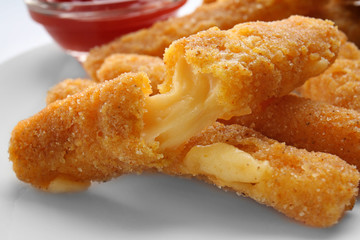 Delicious fried cheese sticks on white plate
