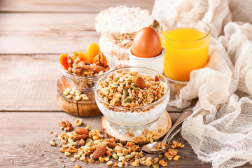 Muesli and yogurt in a glass on a table. Selective focus. Copy space for text