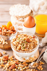 Muesli and yogurt in a glass on a table. Selective focus. Copy space for text