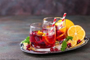 Drink with a lemon and a cranberry. Selective focus. Copy space