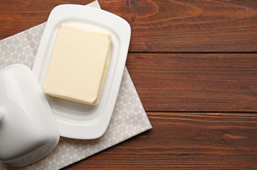 Composition with butter on wooden table