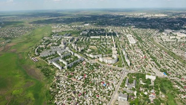 Amazing aerial shot of Kherson city with its multistoreyed buildings, private houses, green parks, which look unusual from a bird`s eye heigh in a sunny day in summer.