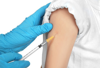 Doctor vaccinating child on white background, closeup