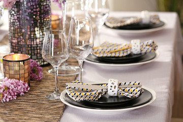 Beautiful table setting with silver cutlery and lilac