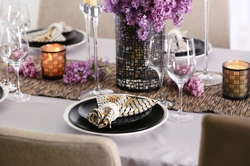 Beautiful table setting with golden cutlery and lilac