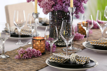 Beautiful table setting with silver cutlery and lilac