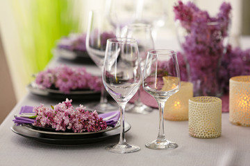 Beautiful table setting decorated with lilac blossom