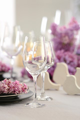 Beautiful table setting decorated with lilac blossom