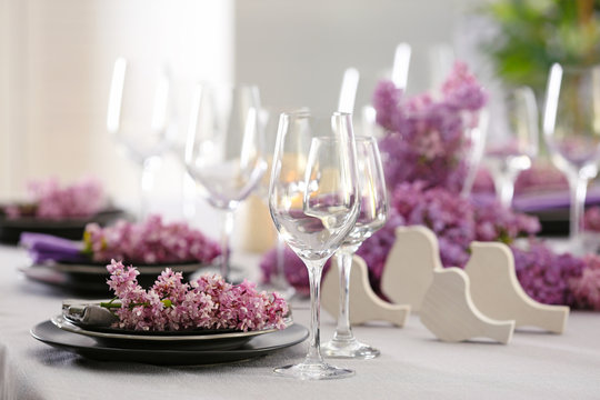 Beautiful table setting decorated with lilac blossom