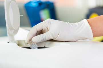 Scientist putting small tube to machine in laboratory