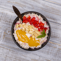 Muesli made from red strawberries, banana, chia seeds, oat flakes, honey and dressed with yogurt