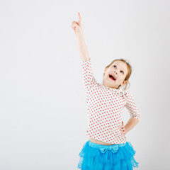 A young girl shows her finger to the side