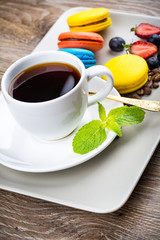 Cup of coffee and pastry on wooden background