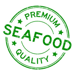 Grunge green premium quality seafood round rubber seal stamp on white background
