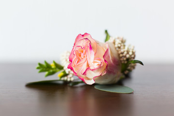 Wedding boutonniere from rose flower and rings