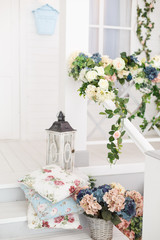 Two Vintage wooden lanterns and patterned pillows. Spring pretty background. Spring and Easter mood. Shabby chic style