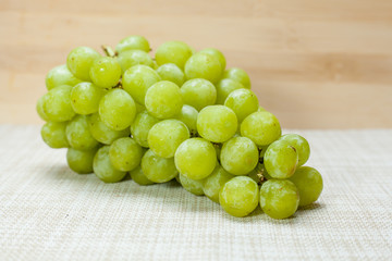 Green grape on brown cloth