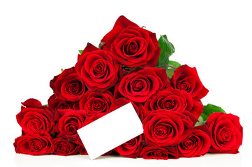 Bunch of red roses and a greeting card isolated on white background