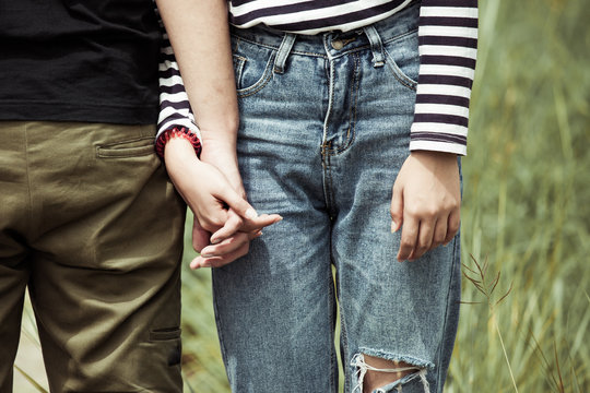 Young love couple holding hands together in vintage color tone