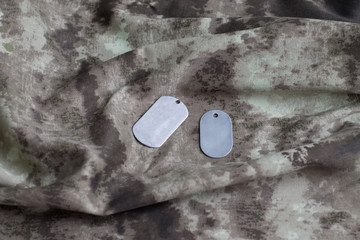 Army badge on the background of camouflage