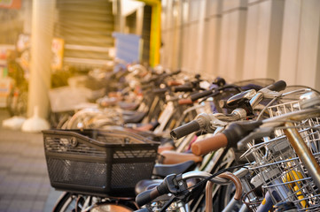 Bicycle parking with gold light in sunrise, Japan