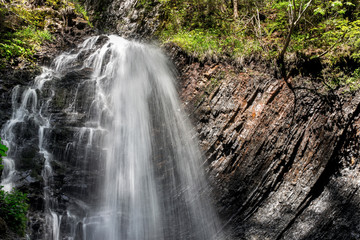 Obraz premium Beautiful Waterfall sunny morning. Beautiful Mountain landscape