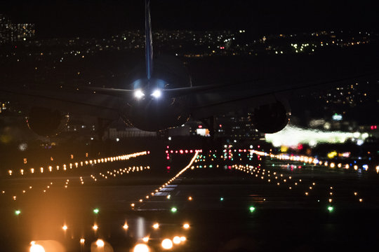 Airplane landing at Osaka International Airport at night