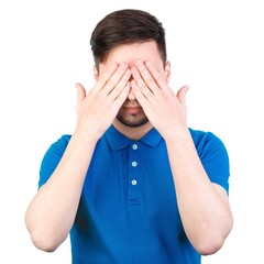 The young man closed his eyes with his hands. Young man covering his ears, closing his eyes,...