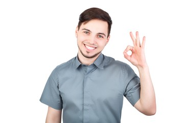 Cheerful young man showing OK gesture. Man showing Ok sign over white background. Handsome business man happy smile, businessman hold hand with ok gesture sign, isolated over white background