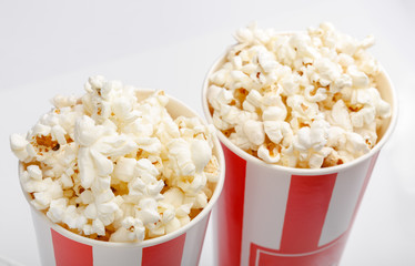 Popcorn in red and white cardboard box. Popcorn border isolated on white. Film. Fast food. Corn
