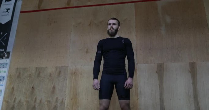 Muscular Man Athlete Portrait Standing In Front Of Wall In Sport Club Before Workout Fitness