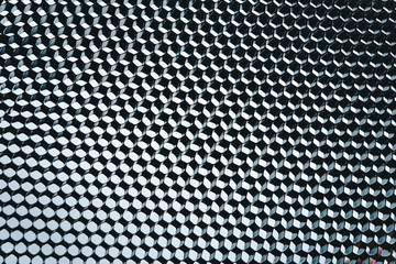 abstract texture honeycomb. Metallic net background or texture. metal mesh. full frame colourful illuminated detail of a metallic grid in front of a loudspeaker. Colorful abstract background.