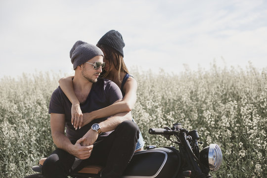 couple in field on motorcycle