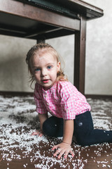Fototapeta premium Little girl is playing with foam balls