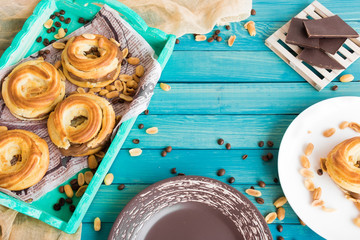 Brewed ring with salted peanuts and chocolate-coffee cream on a turquoise background