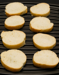 bread is cut into eight pieces and decomposed on a black background