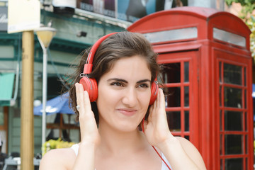 Young woman with red headphones.