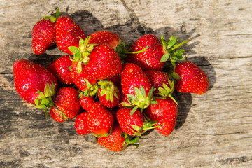 Ripe fresh strawberries on rustic wooden background. Top view