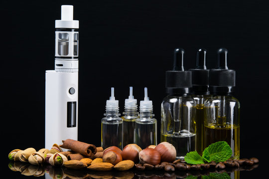 Liquid for an electronic cigarette in bubbles surrounded by nuts, cinnamon and fresh mint