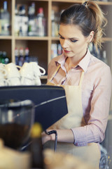 Waitress using coffee machine at work