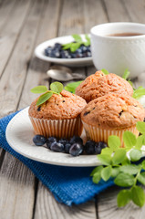 Homemade  blueberry muffins on rustic wooden background, selective focus