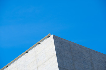 Gray facade like a pyramid over a deep blue sky